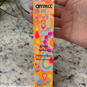 amika bright orange bottle with pink, yellow and blue accents
